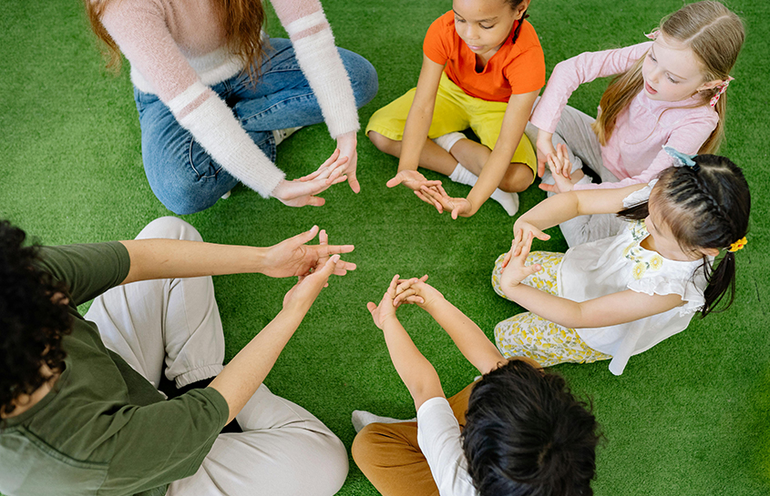 Children playing and developing skills on a preschool playground